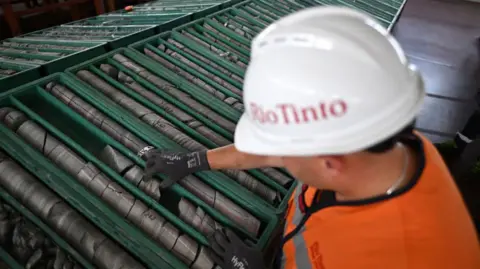 Oliver Bunic/Bloomberg An employee works on sample trays of jadarite, containing lithium and borate, at the Rio Tinto Group research center in Loznica, Serbia, on Friday, July 12, 2024