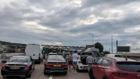 X/@GimmeCake Cars queue to check in at the Folkestone Eurotunnel Le Shuttle terminal