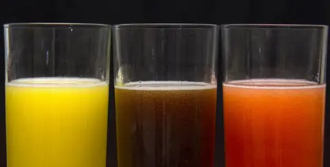 PA Three soft drinks in glasses side by side