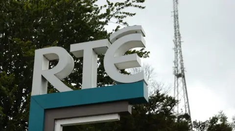 PA Media A sign of the RTÉ broadcaster logo, with a tree in the background