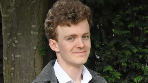 Sam Carling Sam Carling, who has brown hair, wearing a white shirt and a grey jacket