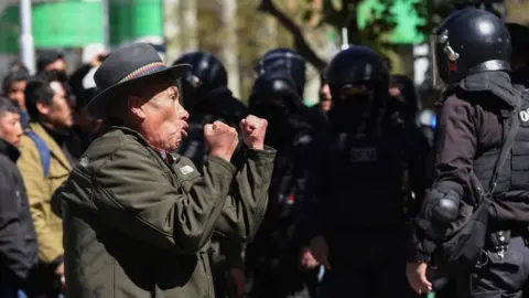 Reuters A man reacts during clashes between supporters of Bolivia's President Luis Arce and supporters of Bolivia's former President Evo Morales outside the Supreme Electoral Court, in La Paz, Bolivia July 10, 2024. 