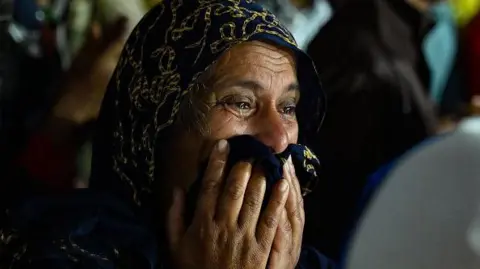 Getty Images A woman cries as she waits at a primary health centre in Meppadi in Kerala's Wayanad district in India on July 30, 2024