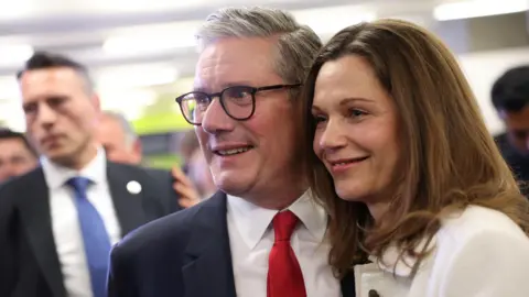 Reuters Keir Starmer and his partner Victoria Starmer smile for cameras