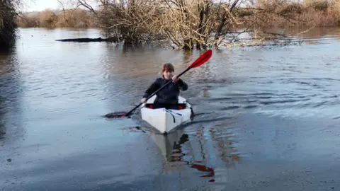 Debbie Wilkins Kayak on a flooded farm