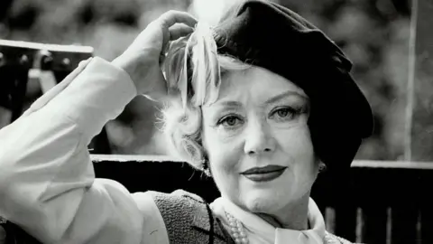 Getty Images A picture of Glynis Johns looking at the camera wearing a hat