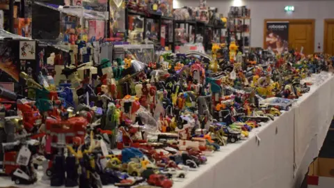 Lyndsay Spence Some of the many Transformers being sold by Toy-Fu at TF Nation in 2024