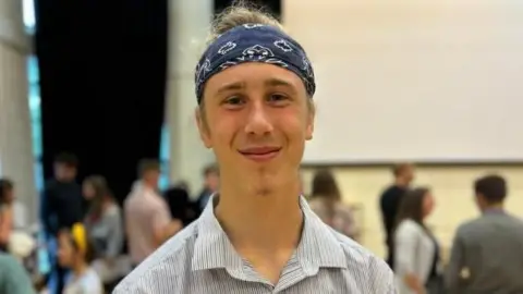 Kingsbridge Community College pupil Milo Clover smiling after picking up his A-level results.