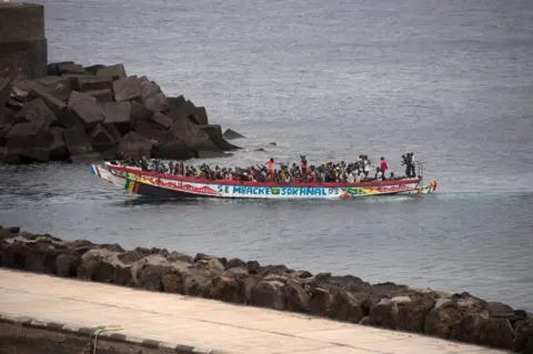 ANTONIA SEMPERE / AFP African migrants, part of a group of 242 migrants onboard two boats, arrive onboard a boat at La Restinga port on the Canary island of El Hierro.