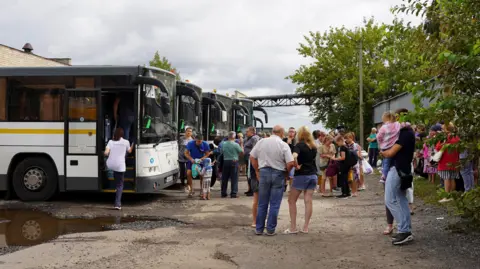 Handout A handout photo made available by the Government of Kursk region of Russia shows people from the border districts of the Kursk region boarding buses to travel to children's camps in the Moscow region, in Kursk, Russia, 09 August 2024.