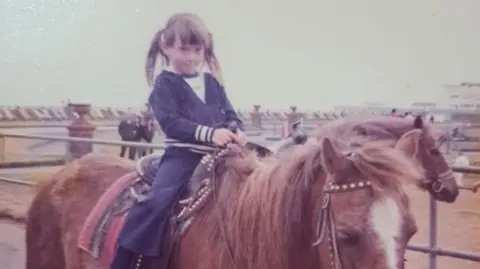 Family tribute Natalie Pearman on a horse as a young child