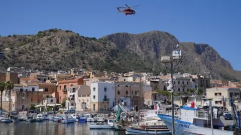 PA Media Rescue helicopter hovers over Porticello in Italy following the sinking