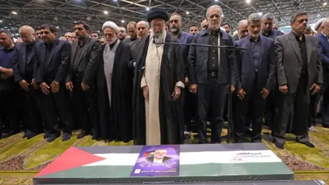 EPA Iran's Supreme Leader Ayatollah Ali Khamenei and others stand behind coffin of assassinated Hamas leader Ismail Haniyeh in Tehran (01/08/24)