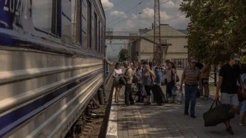 Getty Images Civilians evacuate from Pokrovsk via train