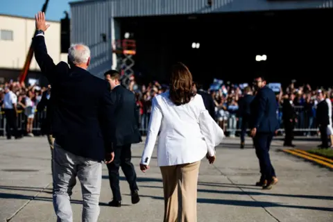 Getty Images Walz and Harris arrive at rally at the Detroit rally