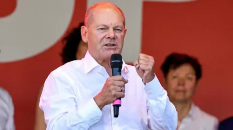 Reuters German Chancellor Olaf Scholz speaks during a Social Democratic Party (SPD) election campaign rally for the Thuringia state elections, in Jena, Germany, August 27, 2024.