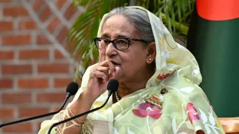 Getty Images Sheikh Hasina holding a finger to her face