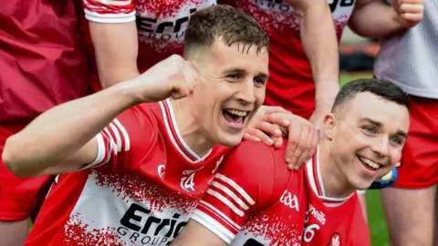 Getty Images Shane McGuigan and Niall Toner celebrate Derry's Division One title win 