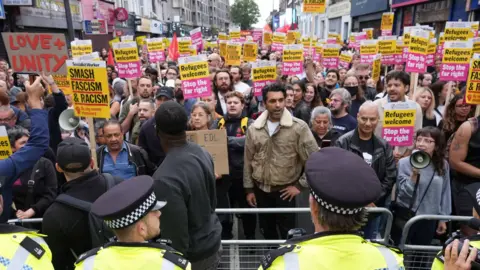 PA Media Demonstrators and police officers at an anti-racism protest in Walthamstow, London