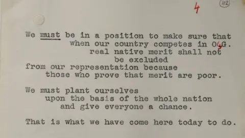 Curtis Brown, London A sepia-toned close up of a paper upon which a speech by Winston Churchill was written, including handwritten correction in red