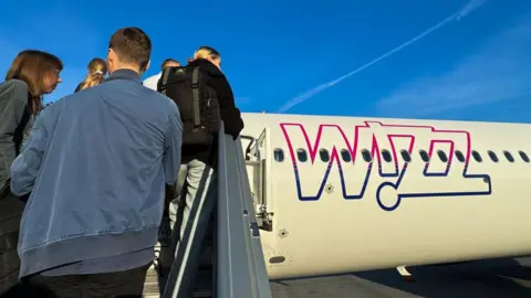 Getty Images People getting onto a Wizz Air flight