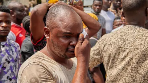 Getty Images Rescuers search for survivors in the wreckage of a 21-storey building that collapsed under construction in Nigeria's largest city, Lagos on November 2, 2021