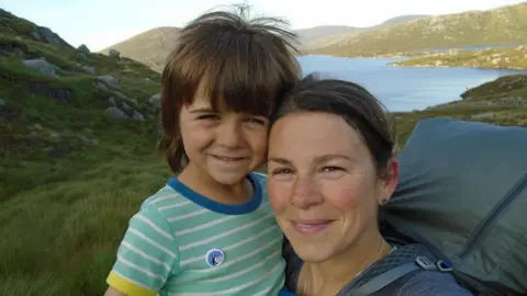 Kerry-Anne Finn and Kerry-Anne in Galloway Forest Park, they are both looking at the camera and there is a tent behind them