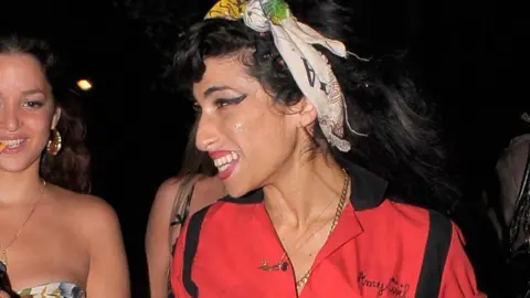 Getty Images Amy Winehouse wearing the red bowling shirt in 2008