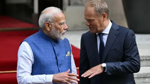 Getty Images Polish Prime Minister Donald Tusk (R) welcomes Indian Prime Minister Narendra Modi for a meeting in front of the Polish Prime Minister's Office in Warsaw, Poland on August 22, 2024. 