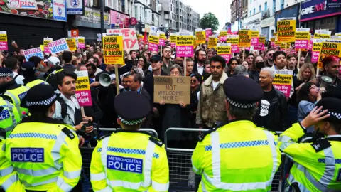 Getty Images Thousands of counter-protesters to a proposed far-right demonstration gathered in Walthamstow on a street outside an immigration centre which had been earmarked as a potential flash point. The Metropolitan Police deployed extra officers to north-east London to maintain a presence in the area