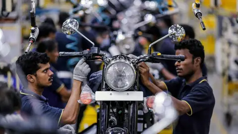 Getty Images Employees assemble Royal Enfield Motors Ltd. Classic 350 motorcycles moving on a conveyor on the production line at the company's manufacturing facility in Chennai, India, on Tuesday, July 14, 2015. I