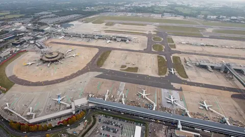 Getty Images An aerial view over Gatwick airport showing planes on the ground.