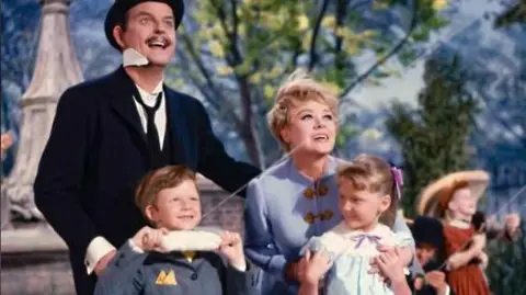 Getty Images Glynis Johns as Winifred Banks in a scene from the film Mary Poppins, with George Banks and the Banks children, Michael and Jane