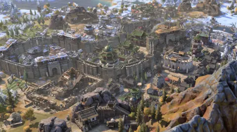 Firaxis A computer-generated image showing a city surrounded by walls, with a mountain in the foreground and snow on the roofs of buildings