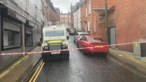 BBC A police Landrover sits on a street in londonderry