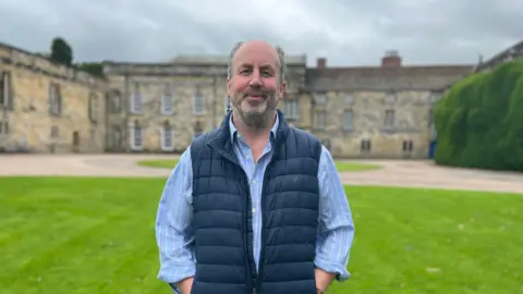 BBC/Julia Lewis Stephen Wombwell standing in front of Newburgh Priory