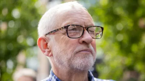 Getty Images Jeremy Corbyn wearing glasses and a plaid shirt 