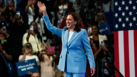 Getty Images Harris at an event in Atlanta waving to the crowd