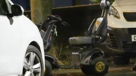 PA Media A black and grey wheelchair was pictured at the crime scene on Wednesday evening