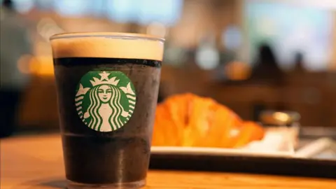 Getty Images A Starbucks drink and a croissant.