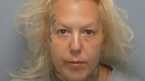 Hampshire Police A mugshot of a woman with light blonde hair and face tattoos