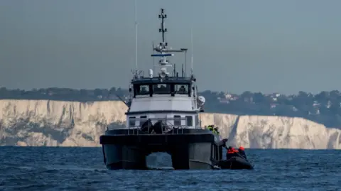 Reuters A British Border Force vessel picks up an inflatable dinghy carrying migrants in the English Channel