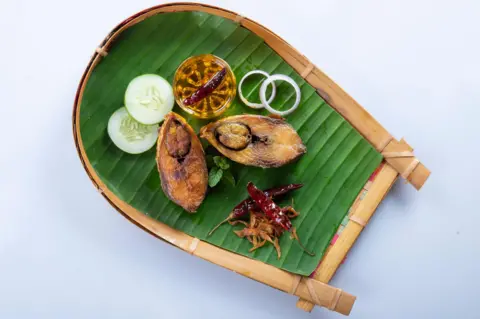 Getty Images Ilish bhaji for Panta ilish, Bengali new year festive dish. Fried Hilsha slices with chilli, tomato and onion. Hilsa fry is popular in pohela boishakh. on kula.