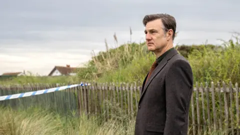 David Morrissey as Ian St Clair staring into the distance