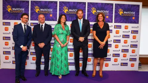 Reuters Prince Harry poses for a picture with General Manager at Royal Lancaster Hotel Sally Beck, Wellchild CEO Matt James, Wellchild Chair of Trustees Craig Hatch, GSK SVP Global Communications and CEO Office Sally Jackson