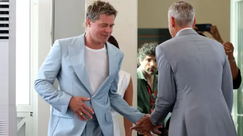 Getty Images George Clooney and Brad Pitt attend the "Wolfs" photocall during the 81st Venice International Film Festival at Palazzo del Casino on September 01, 2024 in Venice, Italy.