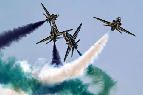 Khaled Desouki /AFP BAE Hawk trainer aircraft of the Royal Saudi Air Force's Saudi Falcons aerobatic team release smoke as they cross in flight