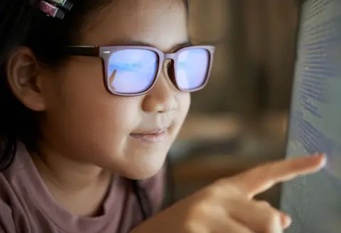 Getty Images Girls wearing glasses looking at a computer screen