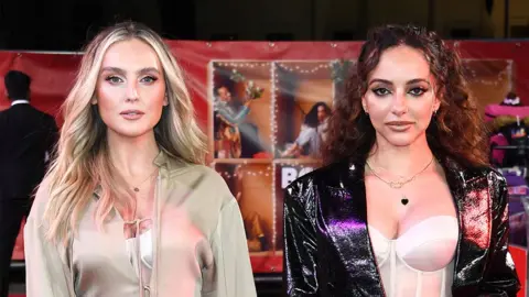 Getty Images Perrie Edwards and Jade Thirlwall standing next to each other on a red carpet event in 2021. Perrie is wearing a cream coloured fleece, and Jade a black leather jacket.