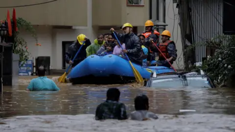 Reuters Security personnel use an inflatable raft to bring residents to safety from a flooded area near the bank of the overflowing Bagmati River following heavy rains, in Kathmandu, Nepal